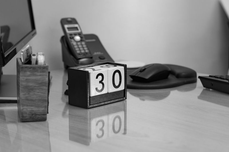 Black-and-white desk calendar block and office phone